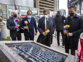 On the fourth anniversary of the deadly Yonge St. van attack Willowdale MPP Stan Cho (from right), Toronto Mayor John Tory, Willowdale MP Ali Ehsassi and Willowdale Coun.John Filion prepare to place flowers during a memorial at North York's Mel Lastman Square on Saturday, April 23, 2022.