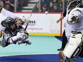 The Calgary Roughnecks' Curtis Dickson (17) shoots against Vancouver Warriors goaltender Alex Buque on Westjet Field at Scotiabank Saddledome in Calgary on Friday, April 1, 2022.