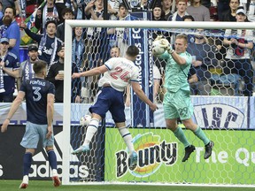 Sporting Kansas City goalkeeper Tim Melia blocks a shot from Vancouver Whitecaps forward Brian White during the first half at BC Place April 2, 2022.