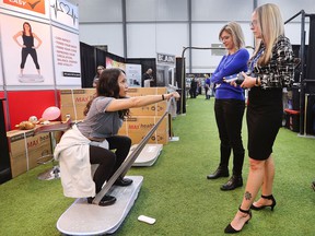 Lala Garcia, left, demonstrates a fitness board to Jessica Ciotoli, center, and Lidia Franzoi at the 38th annual Windsor Home and Garden Show at the Central Park Athletics on Friday, April 29, 2022.