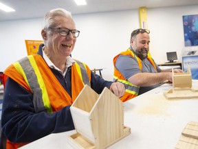 Councillors Jim Morrison, left, and Rino Bortolin, compete in a fun DIY birdhouse competition at the Budimir Branch of the Windsor Public Library, on Wednesday, April 13, 2022. The event was held to launch stage 2 of the Off the Shelf campaign, which is focused on tool lending and many DIY resources.