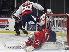 Windsor Spitfires' winger Kyle McDonald flies over Oshawa Generals goalie Patrick Leaver during an exhibition game on Sunday at the WFCU Centre.