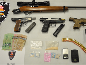 Windsor police have released this photo of the guns, ammunition, cash and drugs found during a Thursday raid of a home in the 1400 block of Pillette Road.