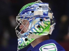 Vancouver Canucks goalie Spencer Martin looks on before an NHL hockey game against the Florida Panthers in Vancouver, on Jan. 21, 2022.