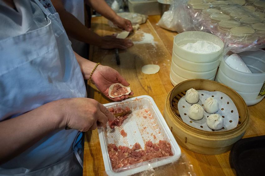 Asian Legend staff prepare steamed soup-filled dumplings at Asian Legend, a Chinatown icon.