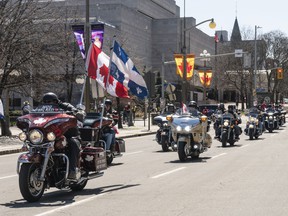 A wave of motorcycles arrive down Elgin St. as they complete their route for the 'Rolling Thunder' convoy on Elgin St. between Albert St. and Laurier St. on Saturday.