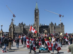 Hundreds of protesters gather on Parliament Hill Saturday afternoon after the passing of the 'Rolling Thunder' on Elgin St.