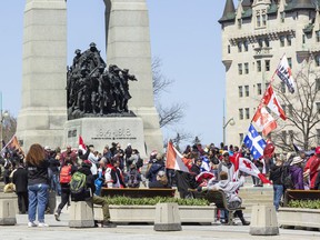 A large group of protesters gather at the National War Memorial on Saturday afternoon after the passing of the 'Rolling Thunder Ottawa' parade of motorcycles on Elgin Street.