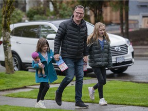 Kevin Falcon, with his daughters Rose, 9, (left) and Josephine, 12, were out door-knocking in Vancouver on Saturday, April 30, 2022.
