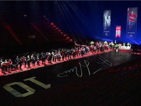 Fans queue to pay their respects during the visitation for late Canadiens player Guy Lafleur at the Bell Center in Montreal on Sunday, May 1, 2022.