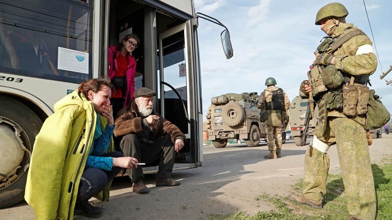 Civilians leaving the area near Azovstal pictured with pro-Russian troops in Bezimenne, some 18 miles east of Mariupol.