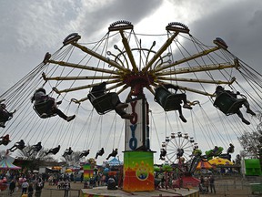 Carnival goers enjoying the Yo Yo swing ride that was one of the rides, plus games and carnival food during the Wild Rose Carnival, a family-operated midway company in the Riverview Crossing parking lot in east Edmonton, May 1, 2022.