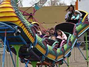 Carnival goers enjoying the Yo Yo swing ride that was one of the rides, plus games and carnival food during the Wild Rose Carnival, a family-operated midway company in the Riverview Crossing parking lot in east Edmonton, May 1, 2022.