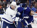 Toronto Maple Leafs defenseman Justin Holl and Toronto Maple Leafs defenseman Rasmus Sandin battle for control of the puck during the second period at Amalie Arena. 