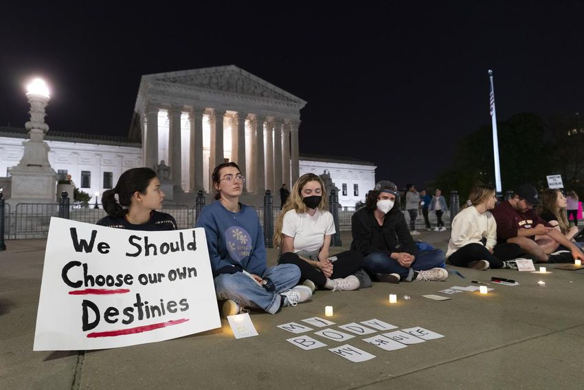 A crowd of people gather outside the Supreme Court early Tuesday, May 3, 2022, in Washington.  A draft opinion suggests the US Supreme Court could be poised to overturn the landmark 1973 Roe v.  Wade case that legalized abortion nationwide, according to a Politico report released Monday.