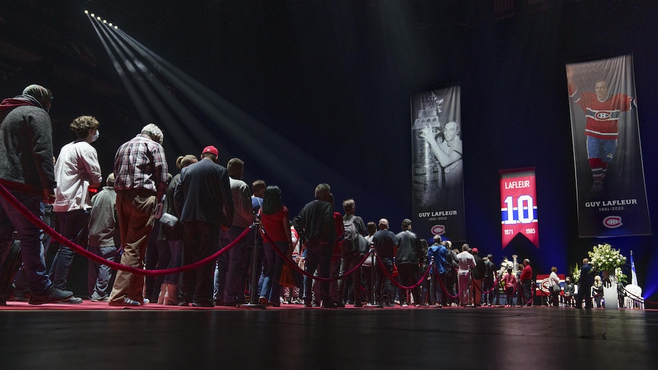 Hockey fans line up to pay their respects to former Montreal Canadiens player Guy Lafleur displayed in a state of worship at the Bell Center in Montreal on Sunday, May 1, 2022.
