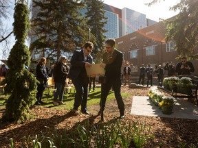 The plaque is placed during the unveiling of a new memorial site on campus in honor of the ten members of the University's community and the three members of their families who were among the 176 people killed in the downing of Flight PS752 at the University of Alberta in Edmonton, on Tuesday, May 3, 2022. Photo by Ian Kucerak