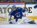 Vancouver Canucks goaltender Michael DiPietro (75) makes a save against the Winnipeg Jets during the Young Stars Classic at the South Okanagan Events Center in 2018.