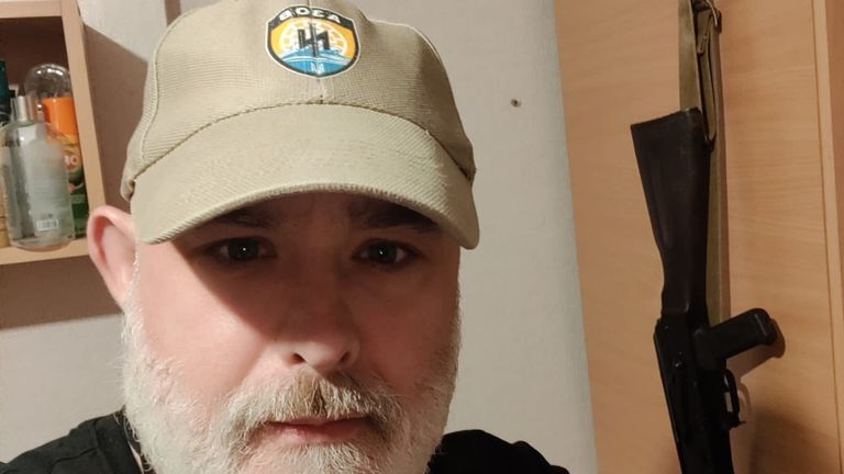 Mark Ayres wearing a hat with the symbol of the Azov unit