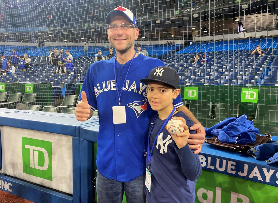 Nine-year-old Derek Rodriguez poses for a photo with Mike Lanzillotta, the Blue Jays fan who caught Aaron Judge's home run ball a night earlier and handed it to the youngster, before the start of American baseball action against the Toronto Blue Jays in Toronto on Wednesday May 4, 2022. The young New York Yankees fan's dreams came true on Tuesday night in Toronto when he was handed a home-run ball hit by Aaron Judge.