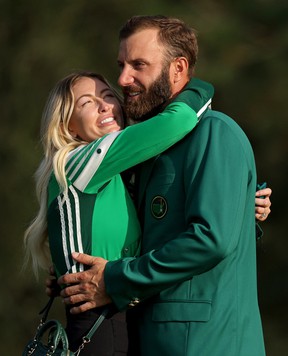 Dustin Johnson of the United States celebrates with fiancée Paulina Gretzky during the Green Jacket Ceremony after winning the Masters at Augusta National Golf Club on November 15, 2020 in Augusta, Georgia.