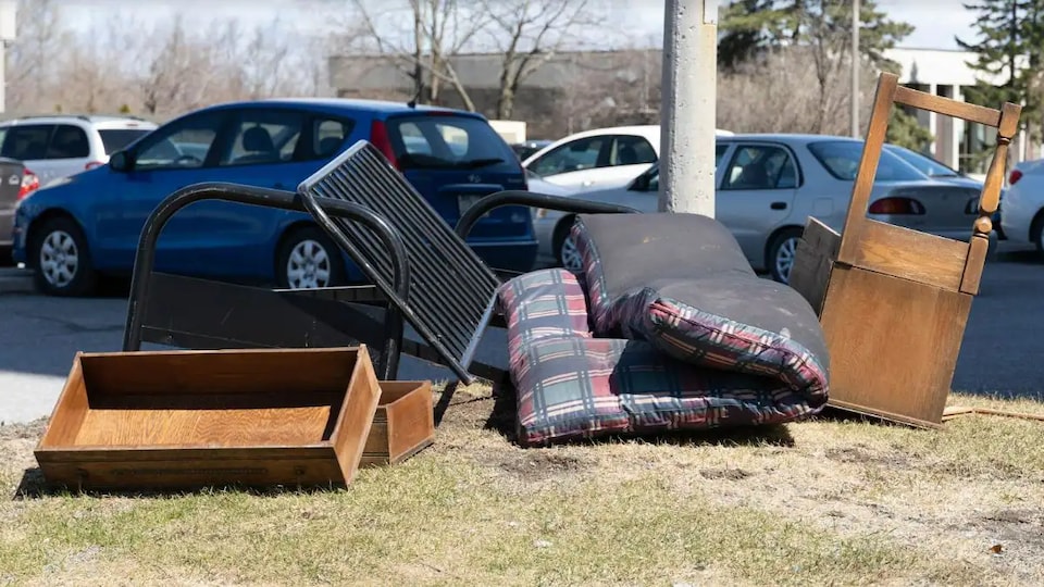 Furniture placed on the side of the road to be thrown away.