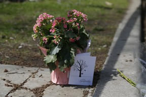Flowers were left at the scene where the remains of a young girl were found in a dumpster on Dale Ave. in Toronto on Thursday, May 5, 2022.