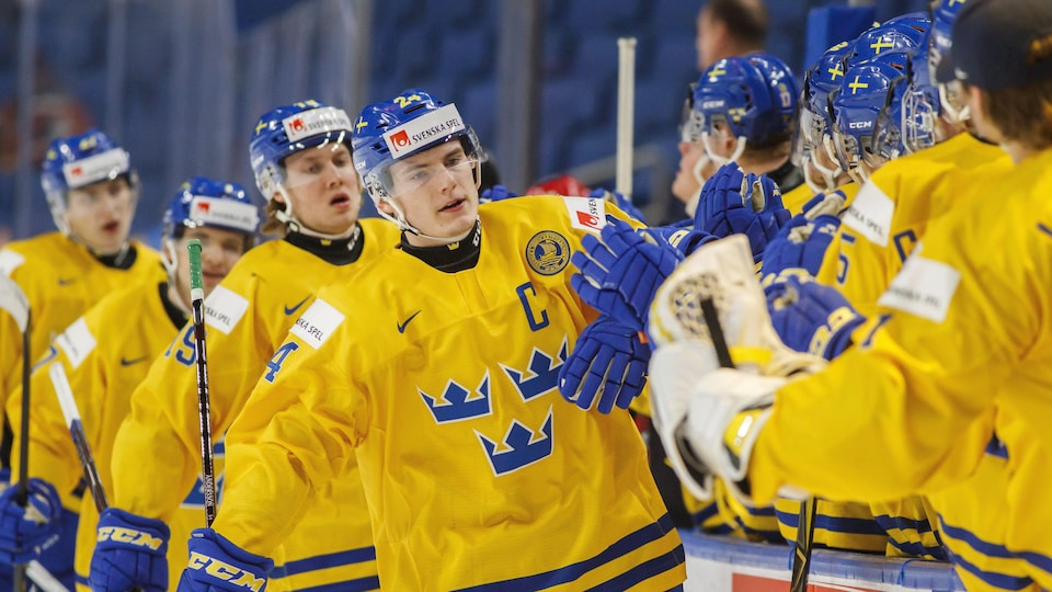 Lias Andersson is congratulated by his Sweden teammates at the World Junior Hockey Championship. 