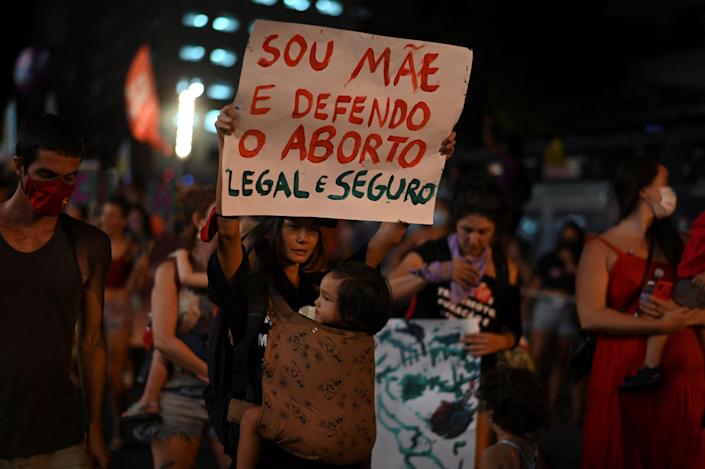 A woman holds a sign in support of legal abortion during a demonstration to commemorate the International Womens Day at the city center of Rio de Janeiro, Brazil, March 08, 2022.