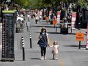 Moire Stevenson and her daughter, Elodie, stroll down the newly created pedestrian mall on Wellington St. in Verdun, on June 15, 2020.