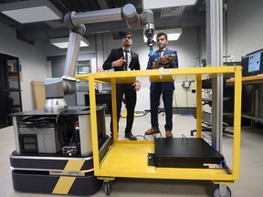 Award winners Yash Soni, left, and Deual Patel, electromechanical engineering-robotics students, participate in the Ford Innovation Showcase competition on Friday, May 6, 2022 at the St. Clair College main campus.