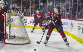 Vancouver Giants defenseman Evan Toth tries to clear the puck during Game 2 of the WHL playoff series against the Kamloops Blazers at the Sandman Center in Kamloops May 7, 2022.