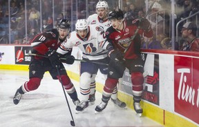 Vancouver Giants Zack Ostapchuk and Damian Palmieri battle Kamloops Blazers Daylan Kuefler and Caeden Bankier during Game 2 of the WHL playoff series May 6, 2022 at the Sandman Center in Kamloops.