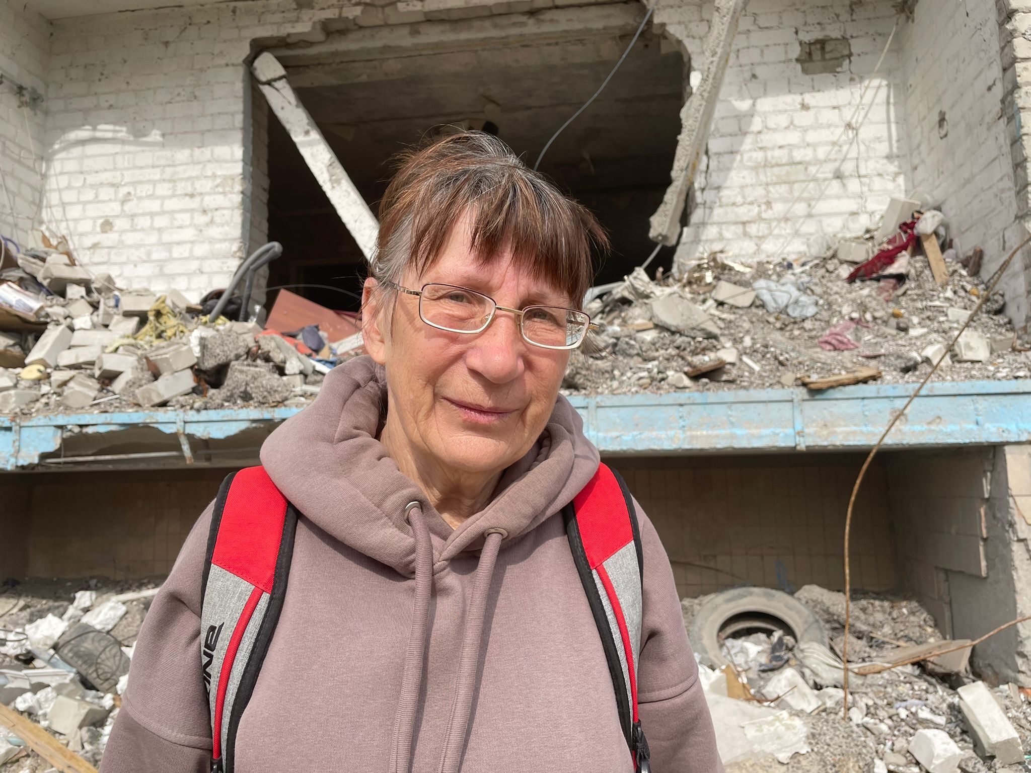 Valentina Torghunshko, a retiree, outside her destroyed home.