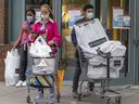 People wear masks as they exit a downtown shopping mall in Montreal Wednesday May 4, 2022. Public health officials announced the end of mask mandates in most situations as of May 14.