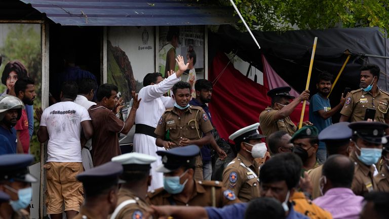 A Sri Lankan Catholic priest, who is also protesting against, is attacked by government supporters outside Prime Minister Mahinda Rajapaksa's official residence in Colombo, Sri Lanka, Monday, May 9, 2022. Government supporters on Monday attacked the protesters who were encamped.  in front of the Sri Lankan prime minister's office, as the unions launched a "week of protests" demanding the change of government and the resignation of its president due to the worst economic crisis in memory in the country PHOTO: AP