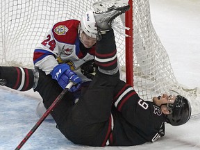 Edmonton Oil Kings Logan Dowhaniuk (24) takes down Red Deer Rebels Kai Uchacz during second period WHL playoff game action in Edmonton on Saturday May 7, 2022.