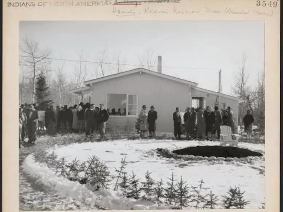 People are photographed in front of a new house during the winter, in Hodgson, in 1960. 