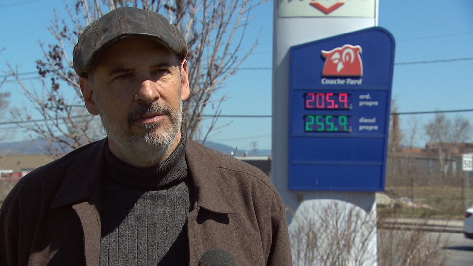 Patrick Gonzalez gives an interview outside, in front of a gas station, in the spring.