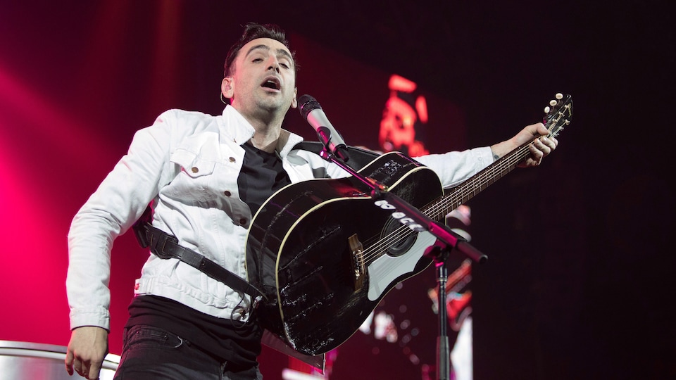 Hedley singer Jacob Hoggard handles the guitar on stage during the last scheduled concert of their Canadian tour, in Kelowna, British Columbia, March 23, 2018.