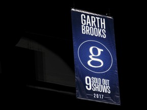 A Garth Brooks banner is revealed in the rafters during a special presentation for the 5 millionth Garth Brooks ticket sold on stage at Rogers Place in Edmonton on Friday, February 24, 2017.