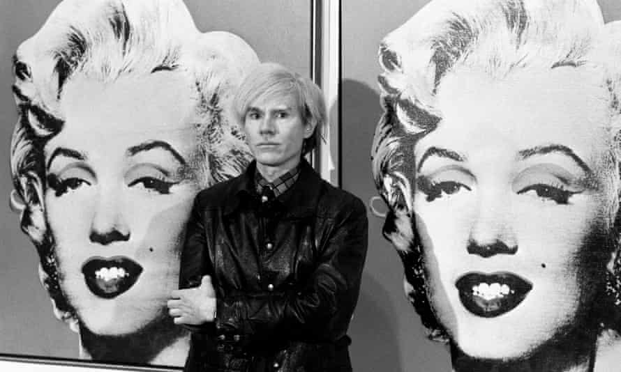 Andy Warhol in front of his double portrait of Marilyn Monroe at the Tate Gallery in London.