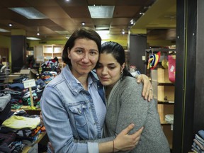“The effects of the war will linger for years,” says volunteer Tatiana Romano, left, embracing Yulia El Hilali at the Ukrainian Newcomers Center.