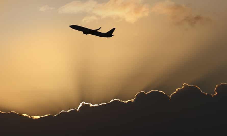 A Virgin Australia Airlines 737 aircraft takes off at sunrise from Sydney International Airport