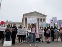Demonstrators hold signs during a protest outside the US Supreme Court after the leak of a draft majority opinion written by Justice Samuel Alito preparing for a majority of the court to overturn the landmark Roe v.  Wade abortion rights decision later this year, in Washington, May 4, 2022.