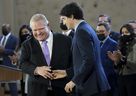 Prime Minister Justin Trudeau, right, shakes hands with Ontario Premier Doug Ford after reaching and agreement in -a-day child-care program deal in Brampton, Ont., on Monday, March 28, 2022. THE CANADIAN PRESS/Nathan Denette