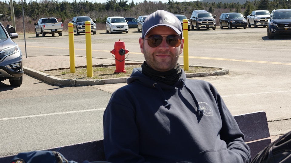 Jean-Martin Leblanc waits on a bench outside the Magdalen Islands airport because of the delay of Pascan's flight. 
