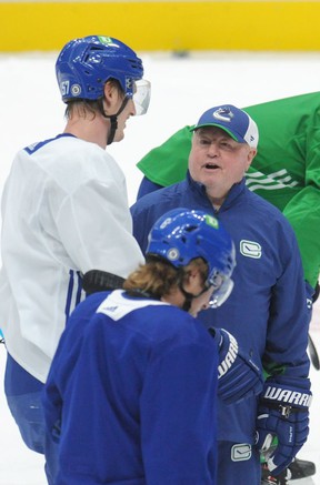 Canucks head coach Bruce Boudreau looks up, way up, in conversation with defenseman Tyler Myers during a December practice at Rogers Arena, shortly after he was hired to salvage a sorry start to the season.