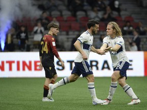 Vancouver Whitecaps forward Russell Teibert (31) celebrates a goal with defender Florian Jungwirth (26) during the first half at BC Place.