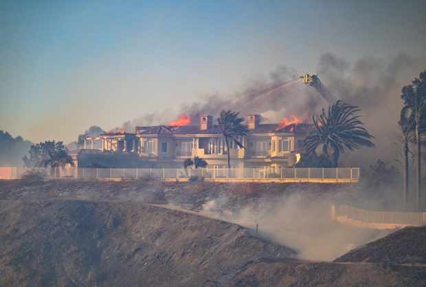 Firefighters battle the Coastal Fire in Laguna Niguel, CA, on...